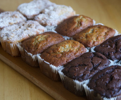 Assorted mini muffins on a wooden board made for catering
