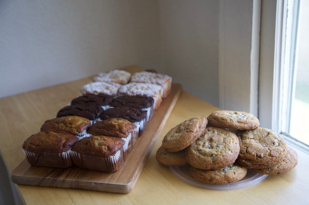 Assorted mini loaves and chocolate chip cookies displayed elegantly for catering