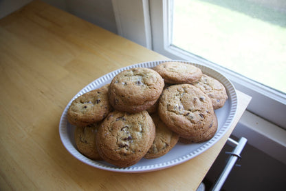 Platter of cookies on a wooden table near a window