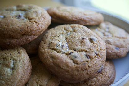 Salted chocolate chip cookies stacked on a plate for the holidays